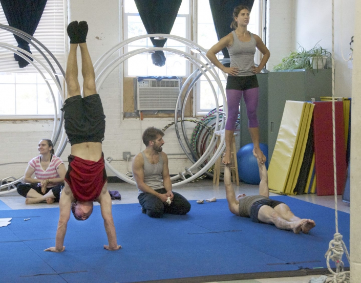 necca-boston-globe-2012-FEAT people training partner acrobatics with a coach at the NECCA studio in the cotton mill