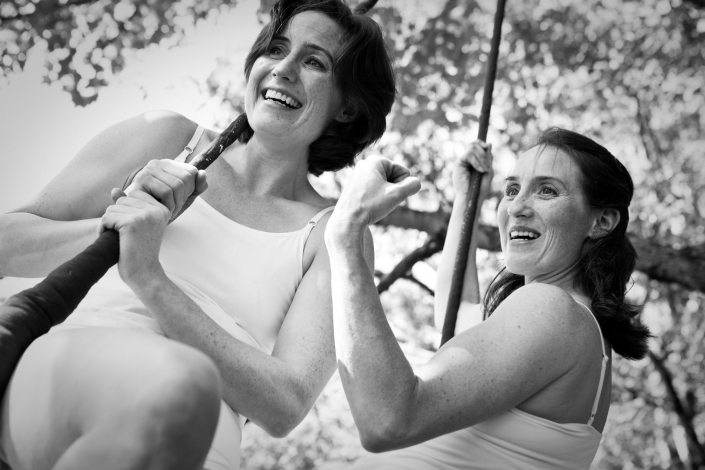 necca-circus-now-april-2015 photo of the founders of NECCA sitting on a trapeze outside in the summertime