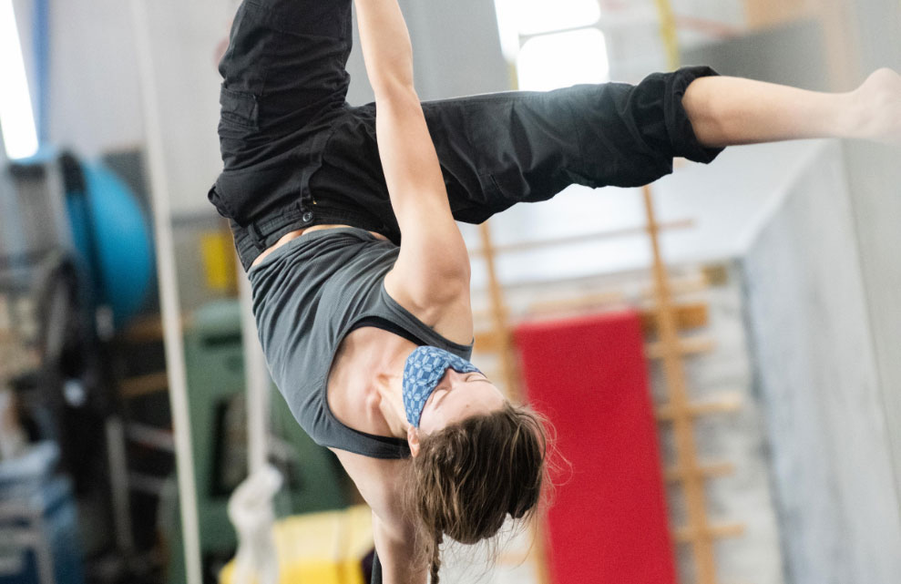 image of an aerial rope artist in the air