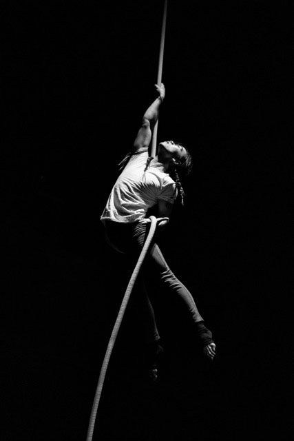 image of a rope artist looking up to the sky while performing